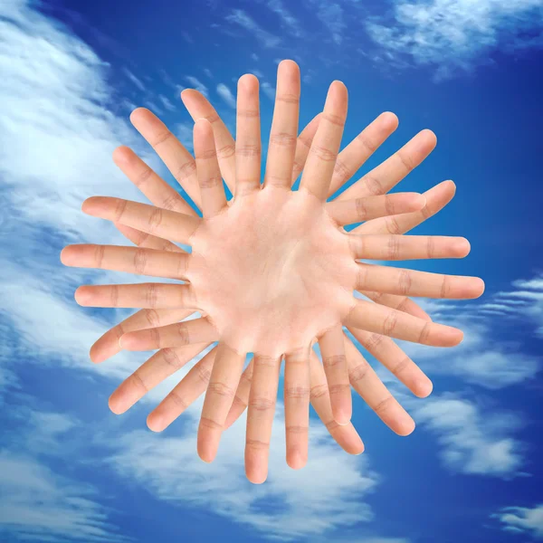 Conceptual sun symbol made from hands — Stock Photo, Image