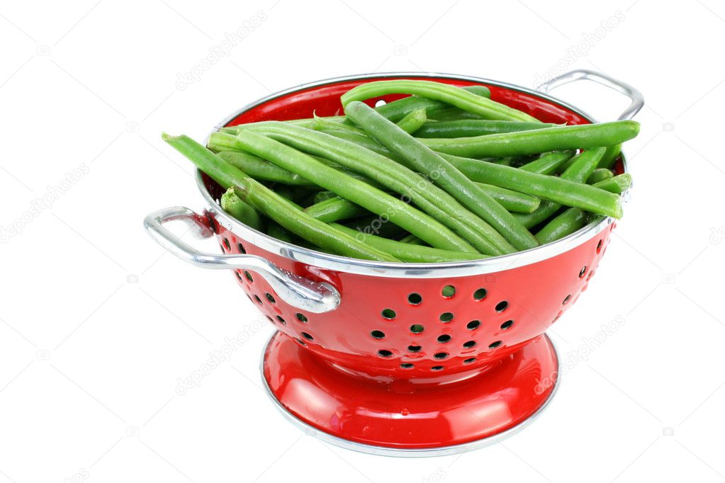 Washed string beans in red colander.