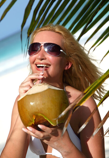 Beautiful blondy holding coconut