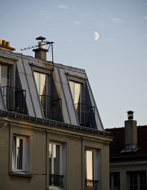 Day half-moon over the parisian roofs clipart