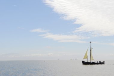 Old ship sails in sea