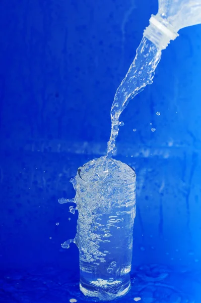 Woda płynie z butelki — Zdjęcie stockowe