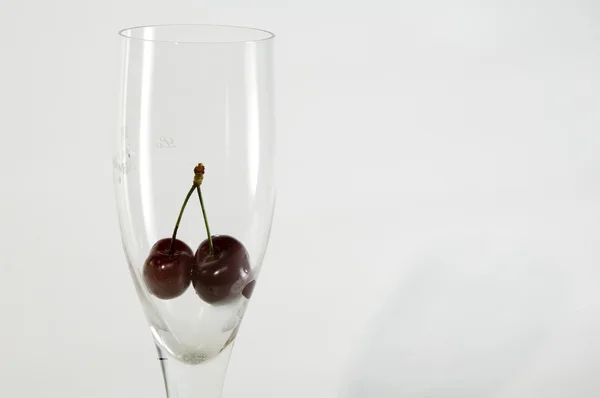 Glass with cherry in it — Stock Photo, Image
