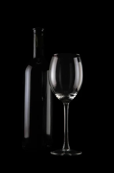 stock image Bottle of wine and empty glass