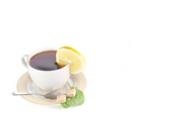 Full cup of tea with lemon — Stock Photo, Image