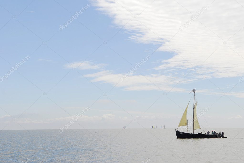 Old ship sails in sea