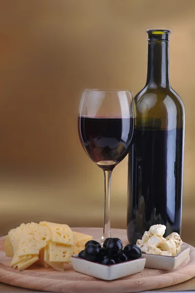 Wine bottle and cheese — Stock Photo, Image
