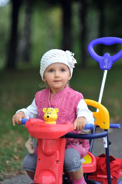 Menina pequena com triciclo — Fotografia de Stock