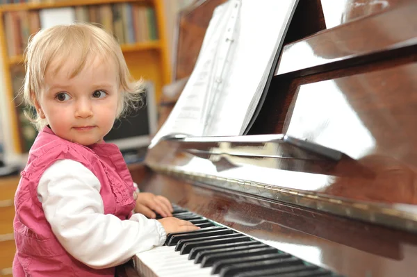 Stock image Girl plays piano