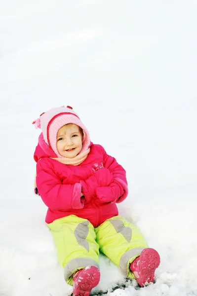 Chica se sienta en la nieve —  Fotos de Stock