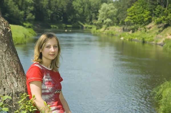 Girl on the river bank — Stock Photo, Image