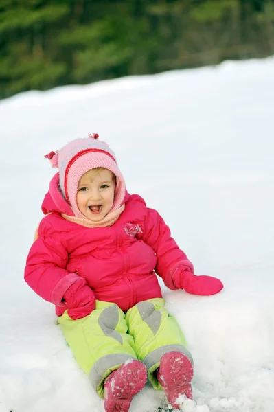 Girl sits on snow — Stock Photo, Image