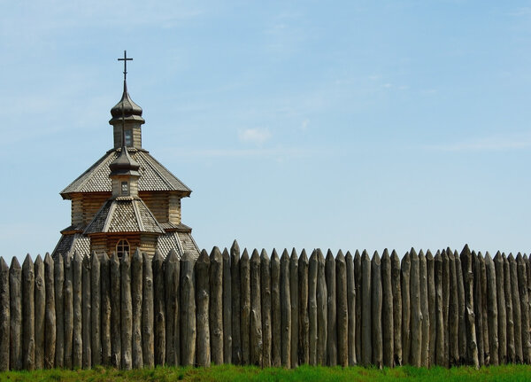 Wooden stockade and a church