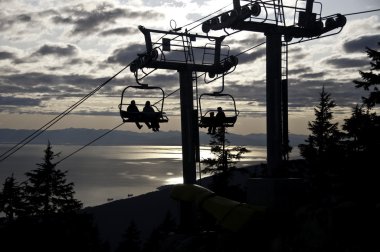 Sunset ride on the chairlift clipart