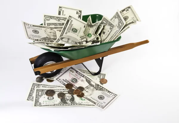 Wheel barrel filled with cash — Stock Photo, Image