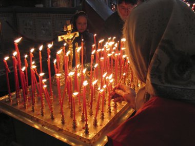 Prayer lightning candle in church clipart