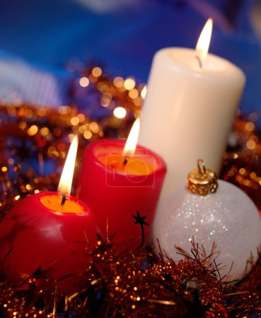 christmas candle and christmas decorations on a blue background 