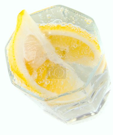 Verre avec de l'eau gazeuse et des tranches de citron 