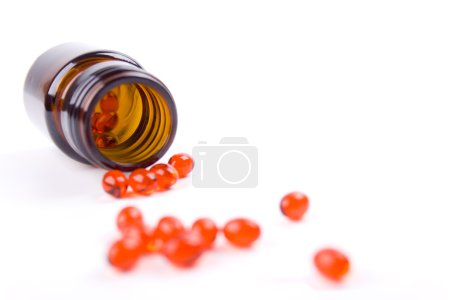 Bouteille avec des pilules rouges 