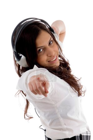 Jeune femme appréciant la musique et pointant 