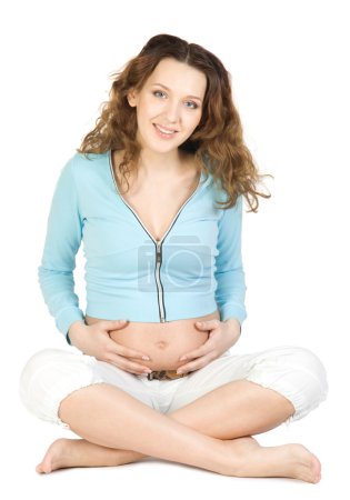 Femmes enceintes assis à la pose lotos 